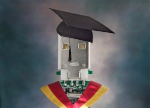 PCB wearing a gown and mortar board